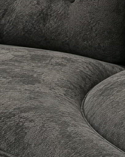 Close-up of charcoal velvet upholstery and piping on curved sofa