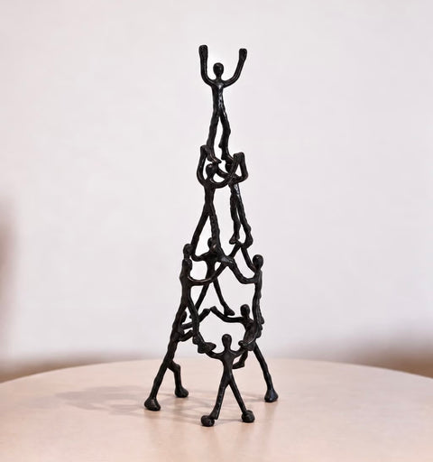 Libra Interiors Tower of Humans sculpture in textured black aluminum, front view