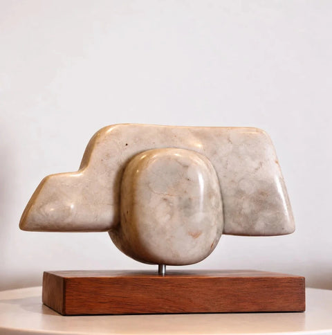 Opposite view of the modernist marble sculpture on a wood base