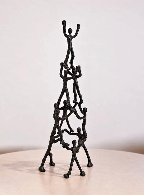 Angled view of stacked figures in Libra Interiors Tower of Humans sculpture