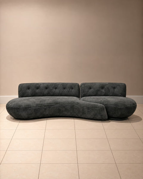 Front view of charcoal velvet curved two-piece sofa with button-tufted backs