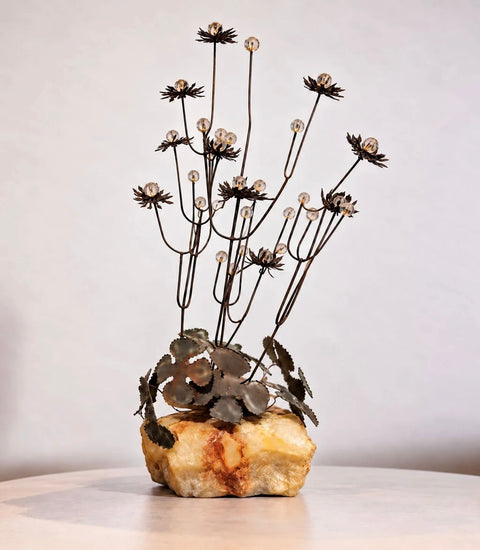 Vintage Curtis Jere-style metal flower sculpture with clear beads on cream-and-amber stone base