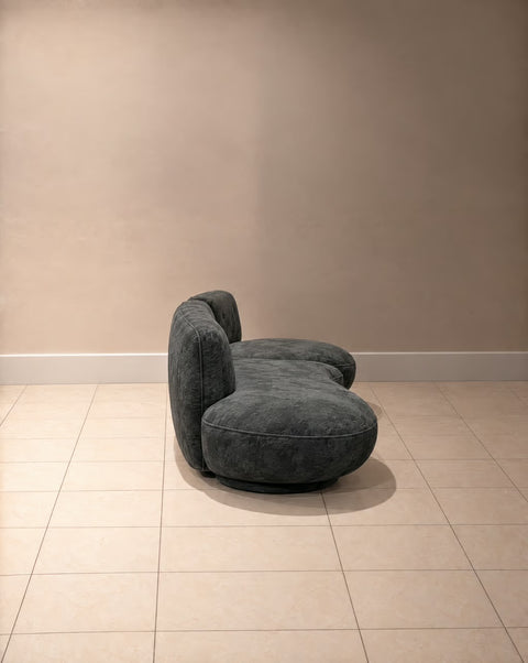 Side view of charcoal velvet curved two-piece sofa