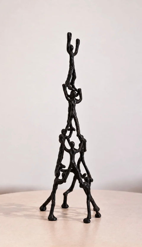 Side view of Libra Interiors black aluminum Tower of Humans sculpture